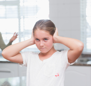 young girl covering her ears